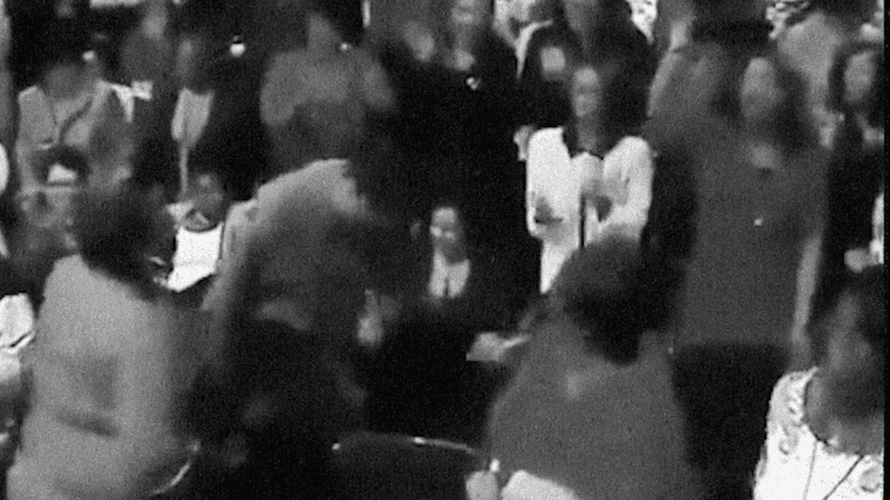 A group of Black church attendees in black and white, with a few people dancing