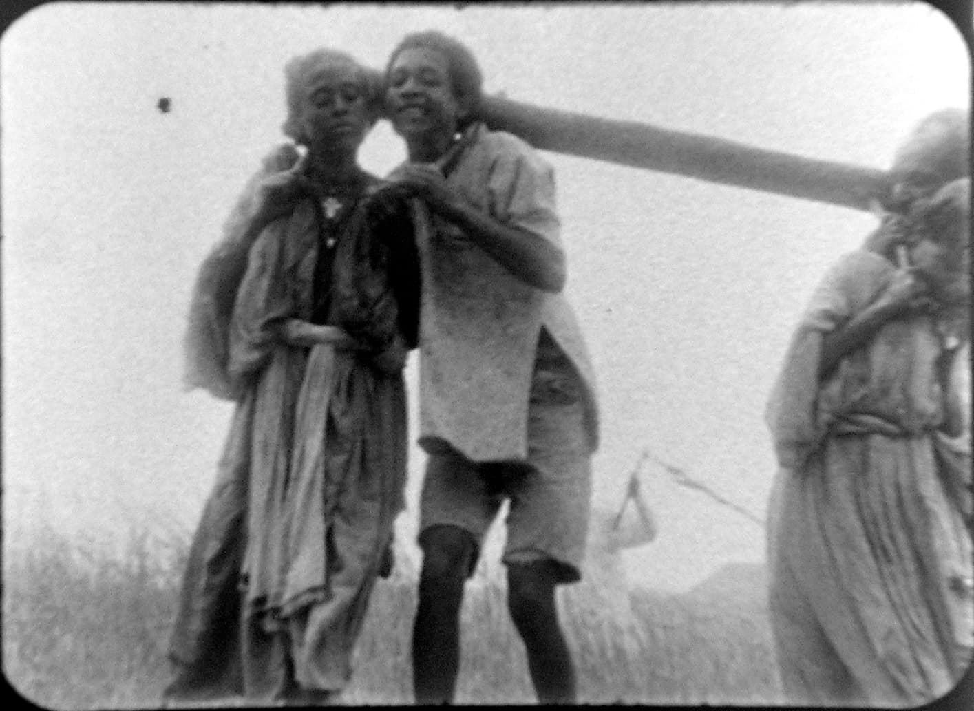 Two people pose for the camera in a black and white photo.