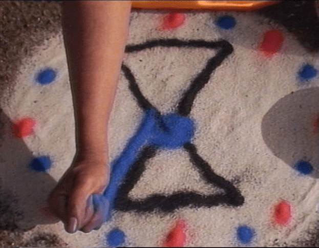 Still from Self Divination (1989). Still courtesy of Ulysses Jenkins. Shows a Black artist's hand drawing shapes.