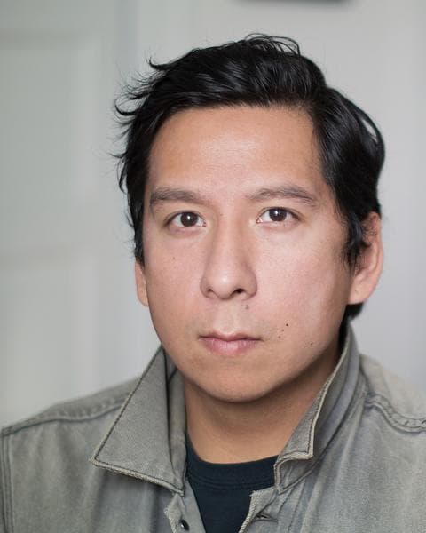 A headshot of Sky Hopinka, an Indigenous man. He is staring directly at the camera with a straight face.