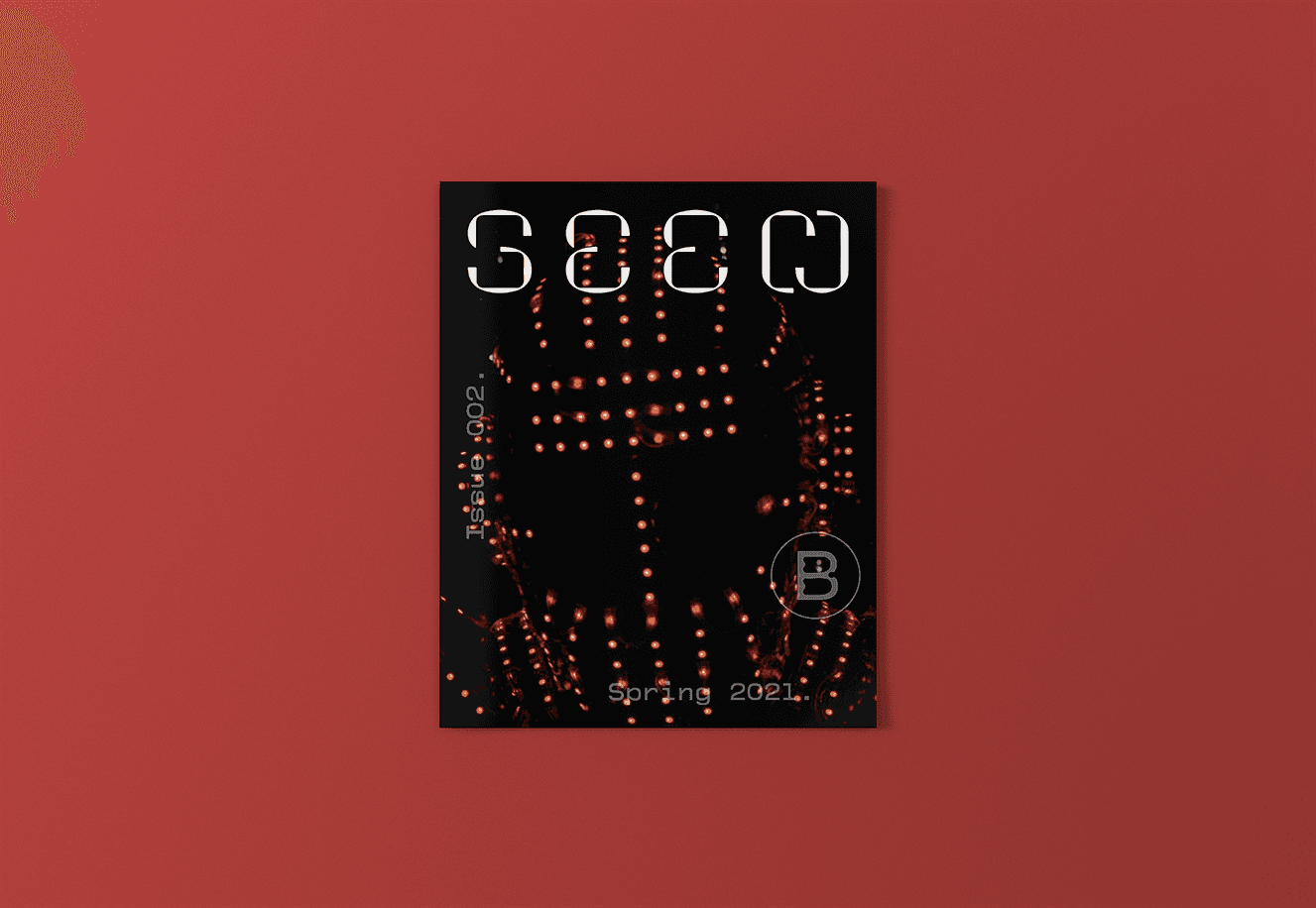 Seen 002 Cover image. Order and subscribe. A helmeted figure is photographed in close up. Red lights adorn and dot the helmet.