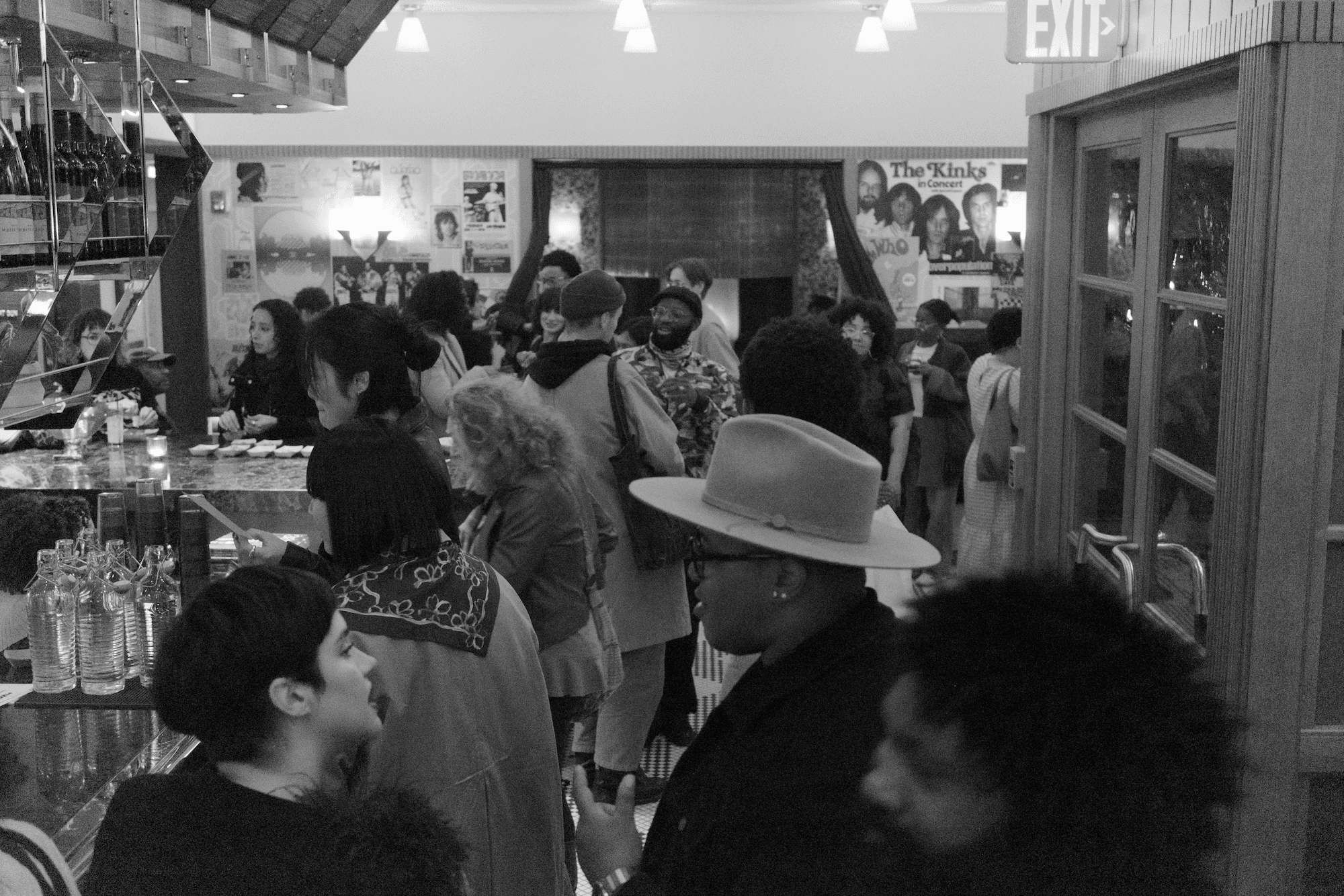 A photo of a crowded room of people mingling.