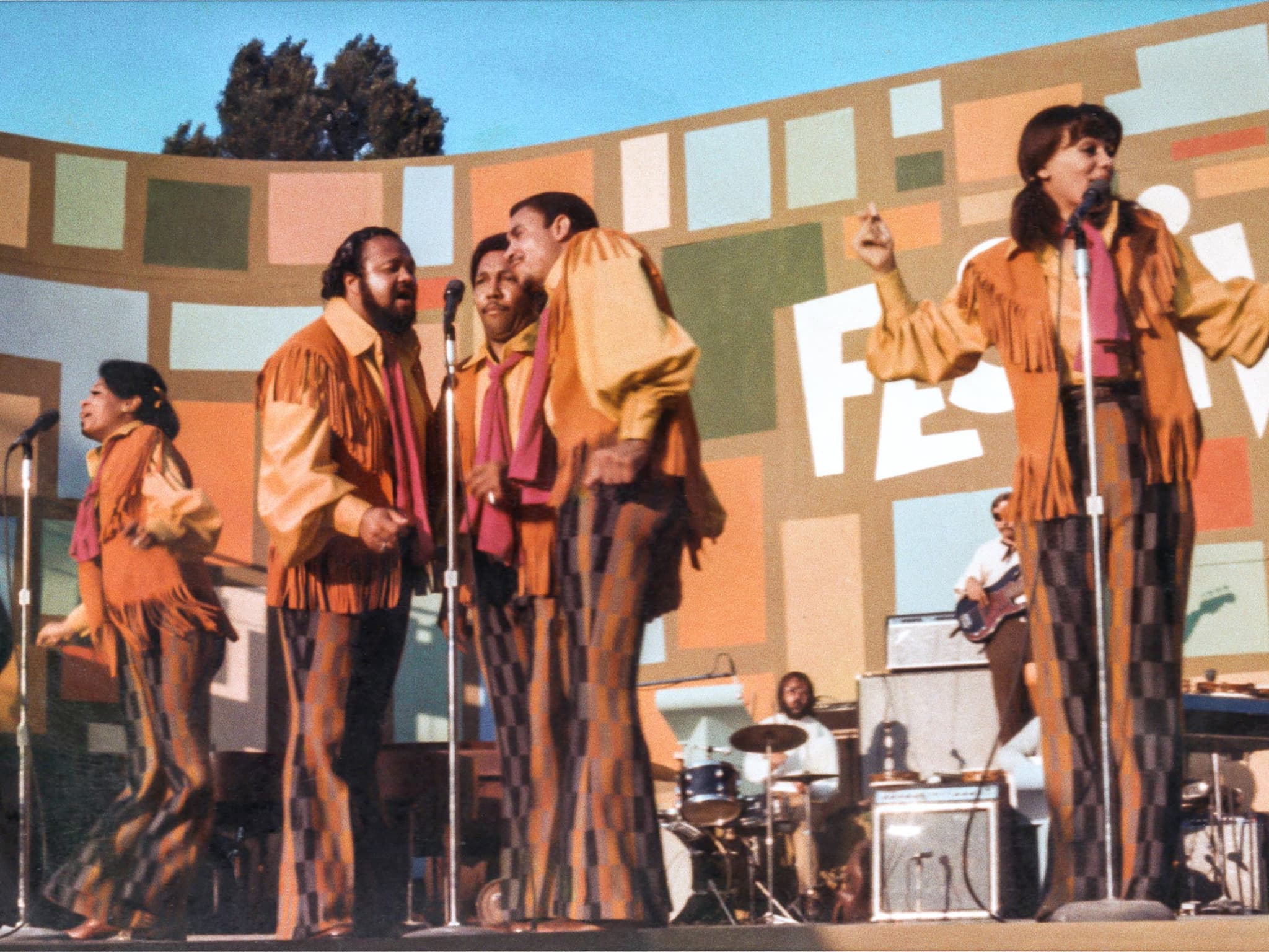 Still from Summer of Soul shows a band of Black performers on stage at the Harlem Cultural Festival in 1969.