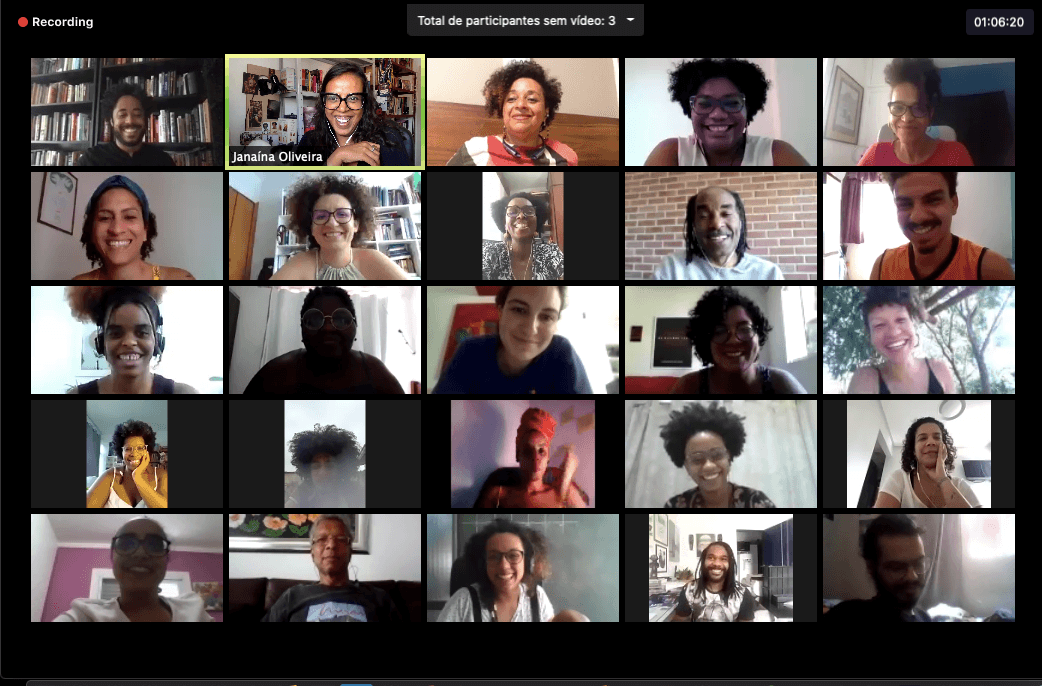 A grid featuring twenty five people on a Zoom video call smile and look at their cameras during a discussion.