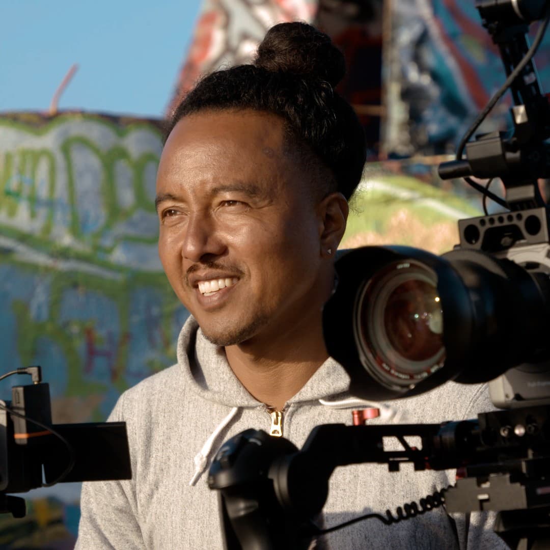 A photograph shows a portrait of Adamu Chan.