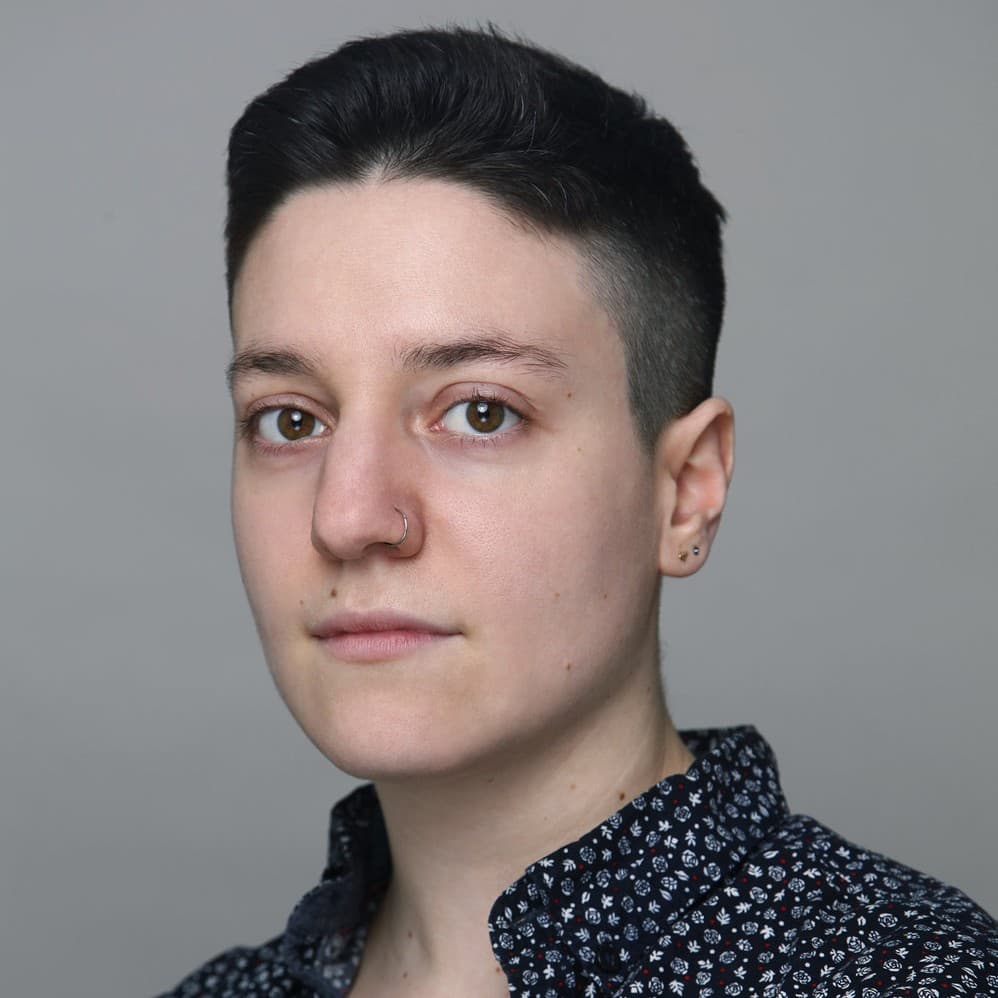 A photograph shows a portrait of Noah Schamus.