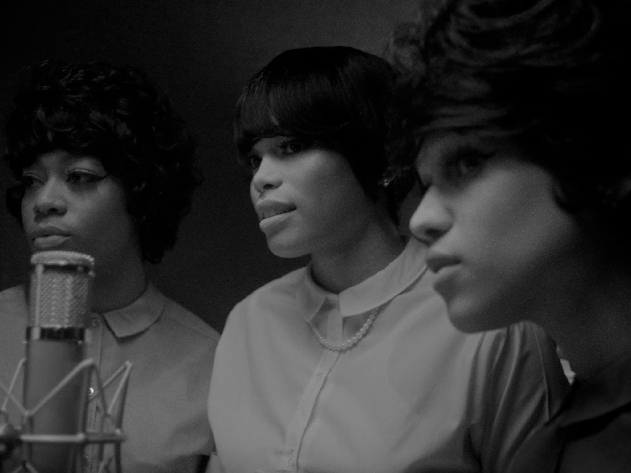 A black-and-white still from Big Three shows a group of three Black singers a recording studio.