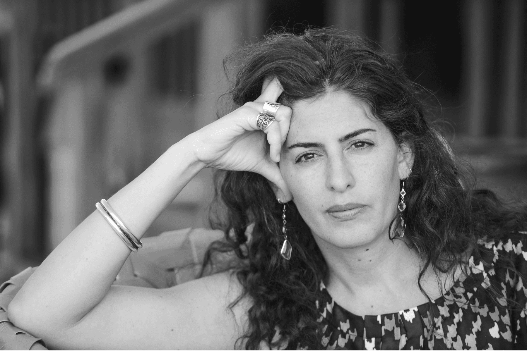A headshot of Annemarie Jacir, looking directly at the camera with a look of intensity.