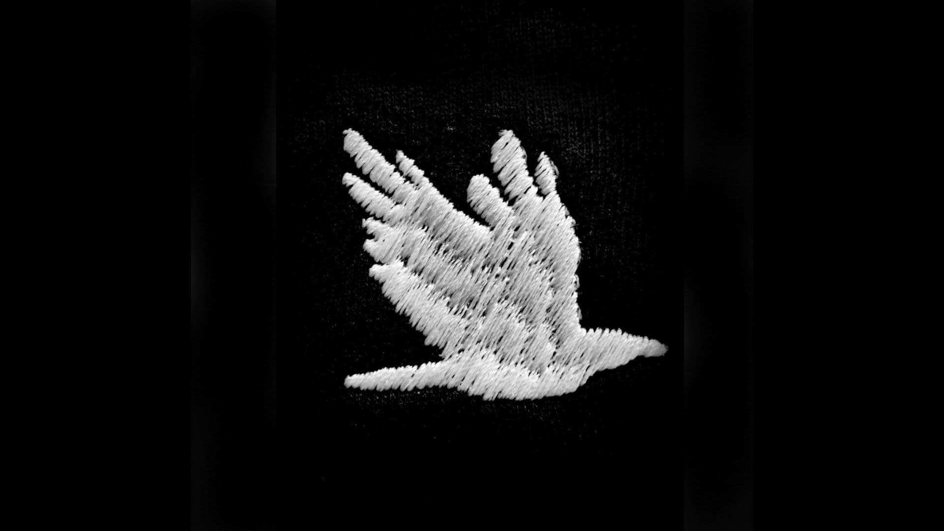 A film still from Our Bodies Ours shows an embroidered white bird mid-flight on a black background.