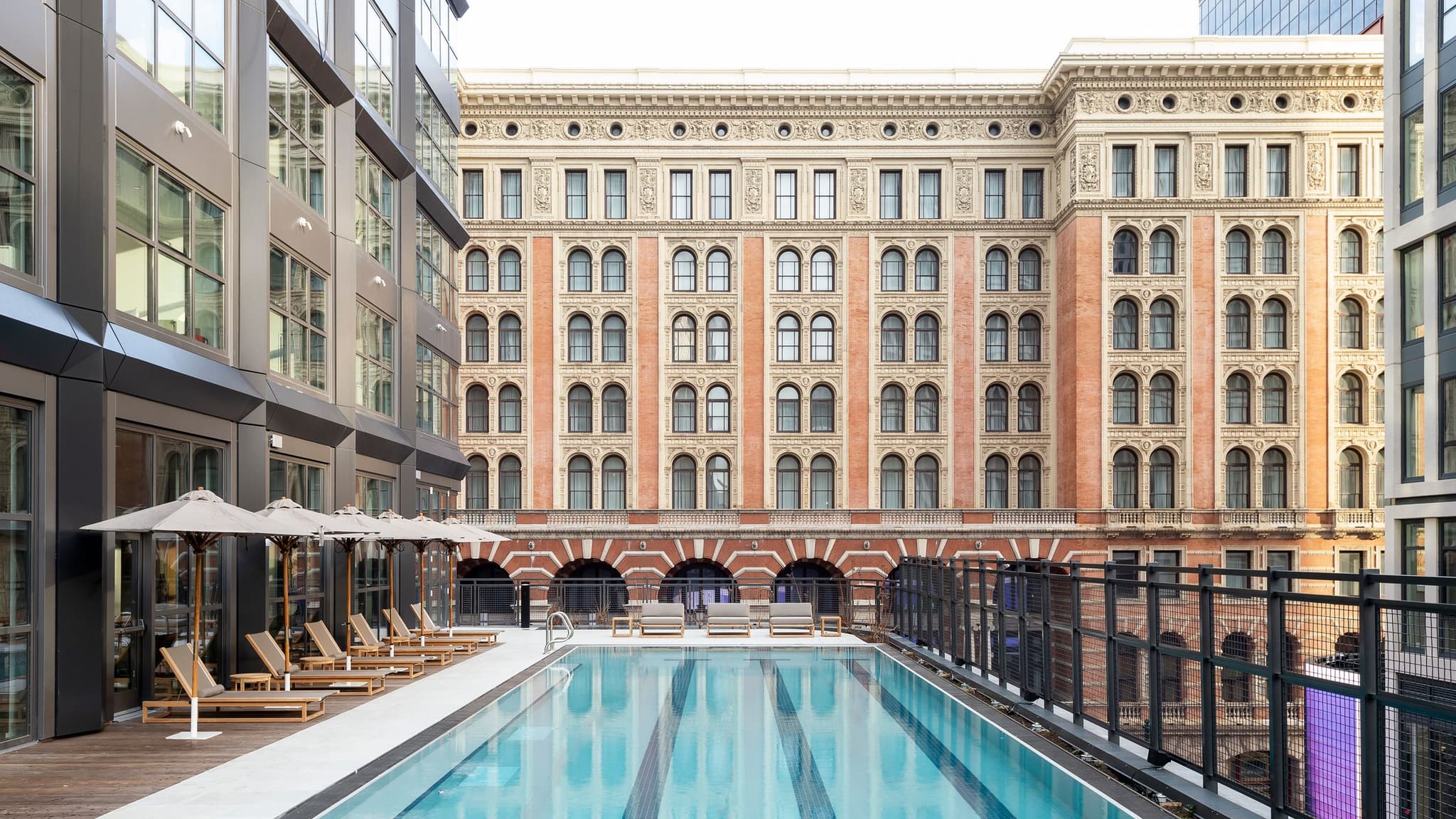 An exterior image of the Roost East Market hotel with pool in the foreground.