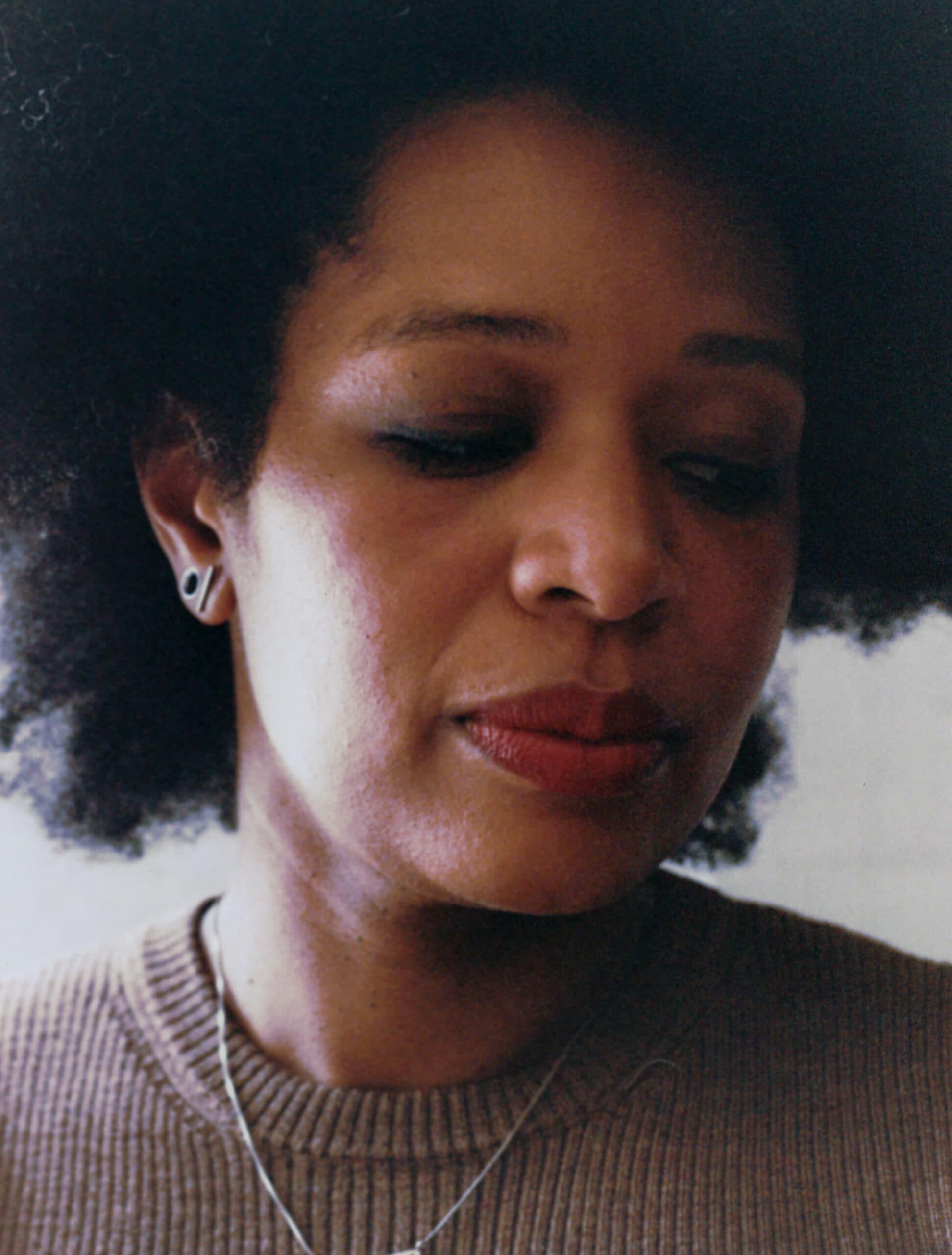 Close up of the artist Allison Janae Hamilton with her eyes closed.